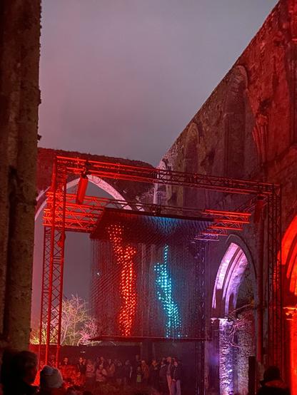 A Illuminated cube with animated dancers in the Beauport Abbey (Paimpol, Côtes d’Armor, Brittany)