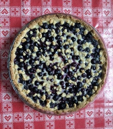 A freshly baked (vegan) blueberry pie on a table