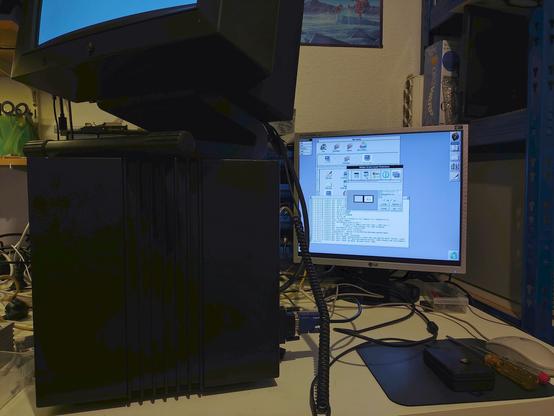 NeXTcube with monitor on top, to the right is a LCD screen showing a NeXT desktop in colour, with the multi-screen control selected in system settings, and a terminal with messages log output identifying the NeXTdimension card
