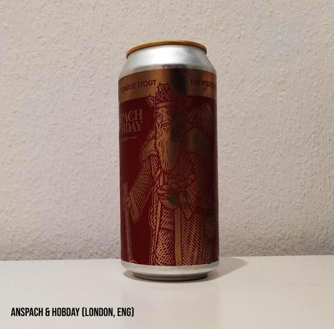 The can is red and gold, with traditional depictions of Saint Nicholas and "Santa".