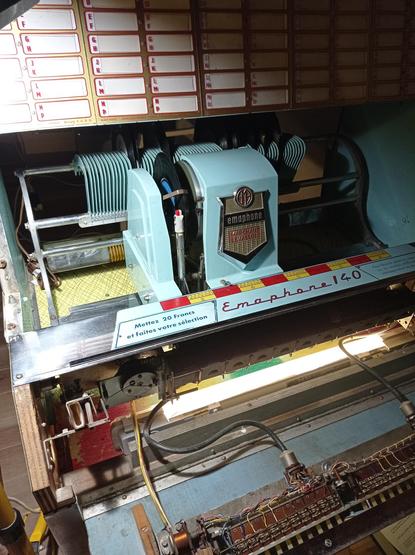 An opened Jukebox with a vinyl disc playing