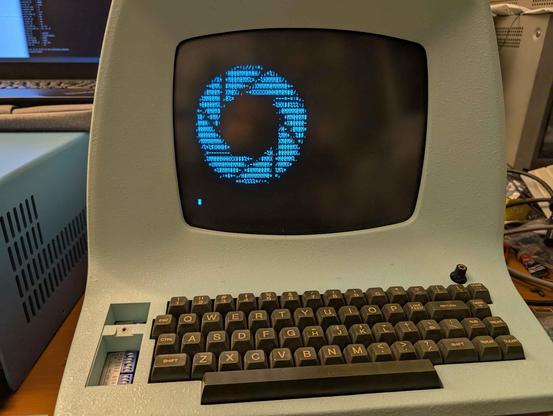 Lear Siegler ADM3A terminal, displaying an ASCII rendition of the Aperture Science logo from the Portal games.