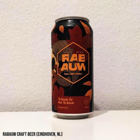 The can is black and shows various tree leaves in different shades of brown and orange.