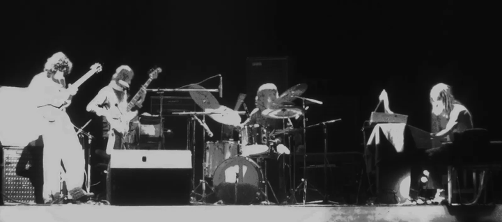 high contrast black and white photo of quartet playing on stage - left to right : Phil, Richard, Pip, Dave
