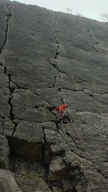 An imposing, dark grey, limestone face, just off vertical and about 30m tall. The face is flat with a number of  crack systems up it with mostly blank rock between. A climber in a red top and grey trousers is approx 1/4 of the way up the crack in the centre of the frame, reaching back to select protection from his harness.

This is Trowbarrow quarry, not far from Kendal in the Lake District. It was my first time climbing in the Lakes and I didn't know at the time that this route - Jean Jeanie - is apparently quite famous; a number of people immediately spotted the route when they saw the pic. It's worth the fame - it's a great route! Personally, I found Harijan more challenging (you can see the top of it as the crack on the right - Harijan comes in diagonally under that from a corner further over), but this was a great lead and I loved every moment of it. 

Again, I managed to arrange a little climbing for the day after a training course - the time Development Coach, with the most excellent John Kettle (hey, if you want to be better at coaching learn from someone who's REALLY good at it, right?) so this is a reminder to myself to try to apply everything I learnt.