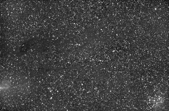 Near infrared image of a winter milky way starfield in Taurus. Some dusty areas have very few stars compared to the rest of the image. Jupiter is just to the left of the lower left edge of the image. The Pleiades are in the lower right corner. The star Menkib is in the upper right corner.

Compare this image with the next, which was taken in visible light. Infrared can look deeper into dust clouds.