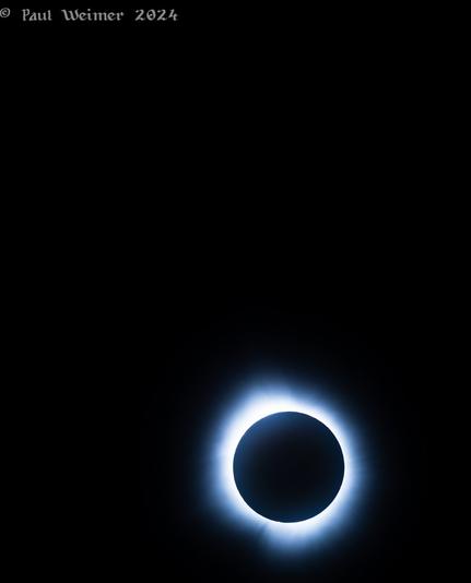 Sun in total eclipse with a white corona around the black sun