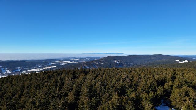 Krkonoše (Giant) mountains towering above layer of clouds.