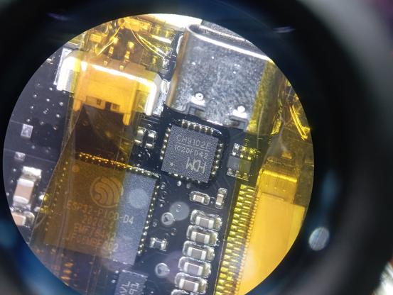 Microscope shot of a CH9102F USB-to-TTL chip on a Watchy board