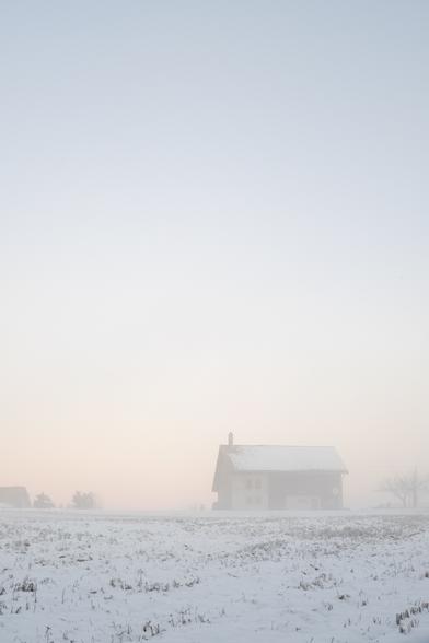 You look to a picture of a distant house in the bottom right corner. It is in a myst and seems distant, lost in a cold cold weather.