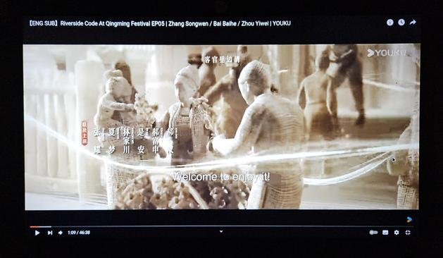 Still from the animated intro of the drama. A family is buying sweets from a cart. All characters are styled to look like they're dolls made out of hemp fabric.