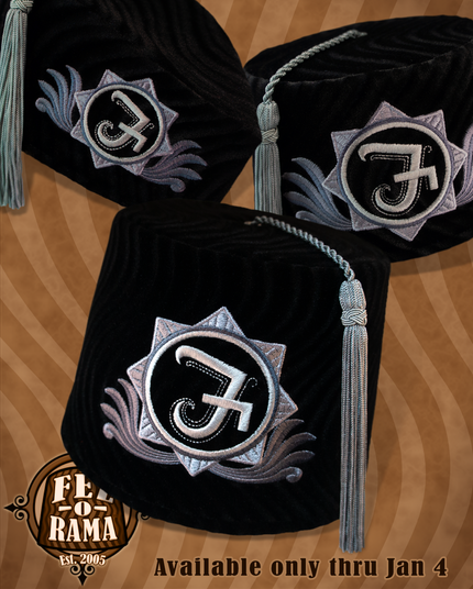 Brimless black velvet hats with embroidered F crests in shades of silver and grey
