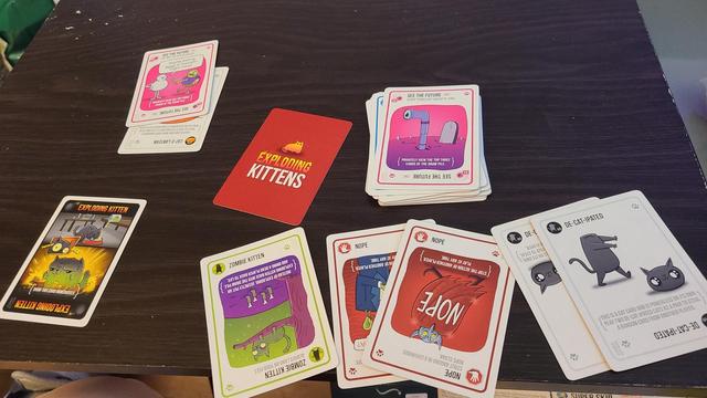 Photo of the end of a game of Zombie Kittens with the remaining cards from both players displayed.