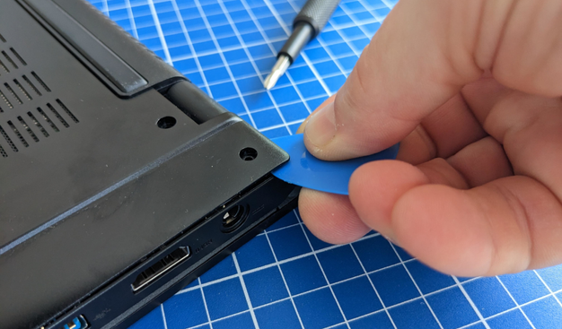 a hand trys to open a tuxedo device with a tile