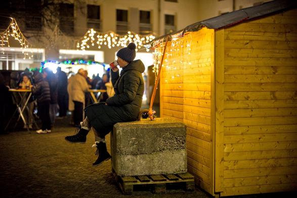 winter market on helgoland in a hurricane. the wooden stalls are secured from flying away by heavy concrete blocks.