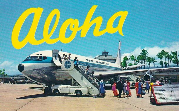 Pan am 707 disembarks passengers at the Honolulu airport.  In the sky, it says Aloha in big yellow letters