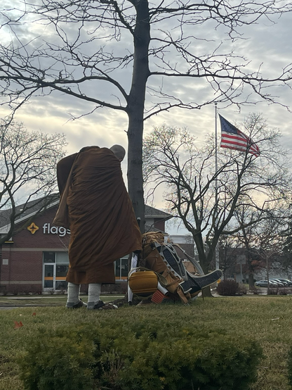A monk putting down his pack to prepare for receiving alms in Michigan.