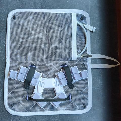 The case fully opened, showing off the additional cable compartment and straps holding down the 18-key keyboard.