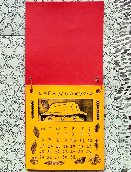 A mini flip-calendar showing the month of January, which features an illustration of detective Tso looking slightly worried, surrounded by leaves and flowers.