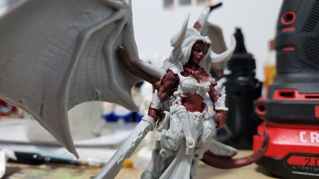 Reaper miniatures bones Queen of Hell mini with wings dry fitted on, now with copper wire pins showing. This pic is from the front right side.