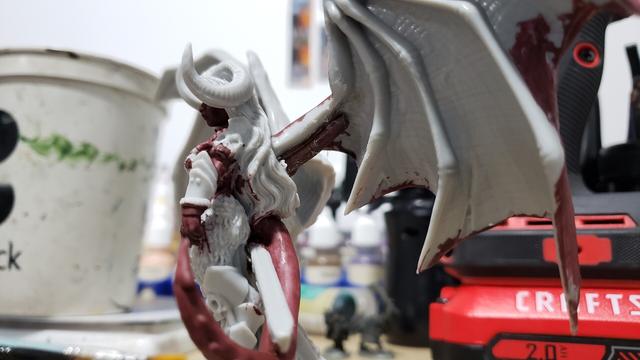Reaper miniatures bones Queen of Hell mini with wings dry fitted on, now with copper wire pins showing. This pic is from the front left side.