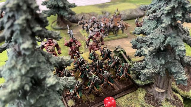 Elf Gladestalkers face an oncoming charge from the Abyssal Moloch’s from within the woodsline . (3D printed Elf archers against classic red painted Chaos Dragon Ogre models)