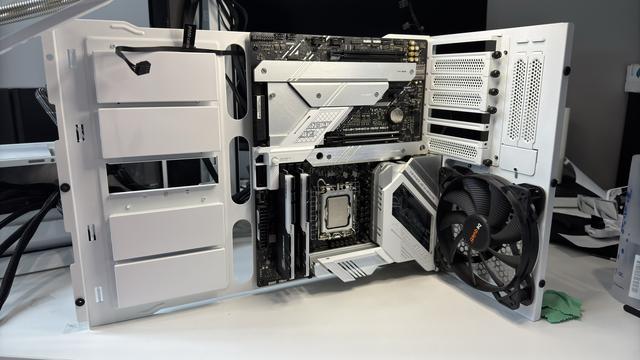 The L-shaped section stood up on its side (such that the L shape itself lays flat on the white desk) so that it now seems to resemble two adjoined walls of a set from a tiny sci-fi film. The stark black circuitry and white and aluminium panelling is quite reminiscent of the opening scenes of Star Wars: Episode IV - A New Hope. A natural toned lamp illuminates the "set" from above.