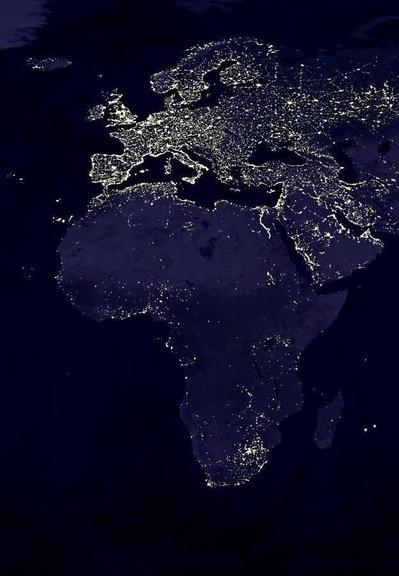 Satellite photo of a lit up Europe and a relatively dark Africa at night