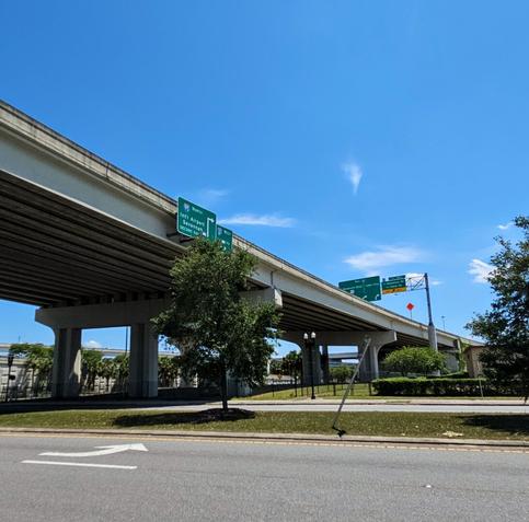 Curved, with slightly sloped section of a bridge overpass.
