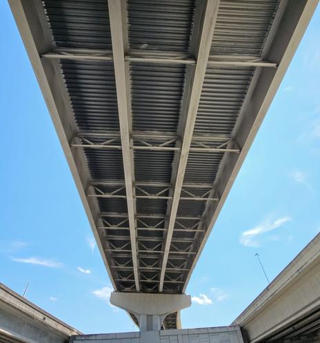 Three different upward sloping on-ramps for a bridge overpass spread out in different directions, high above almost like lanes of a rollercoaster.