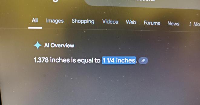 Google AI overview which reads,  "1.378 inches is equal to 1 1/4 inches"