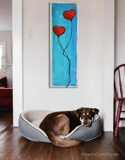 Two big red hearts entwined in a dance on blue.  Hand painted by artist Sharon Cummings.