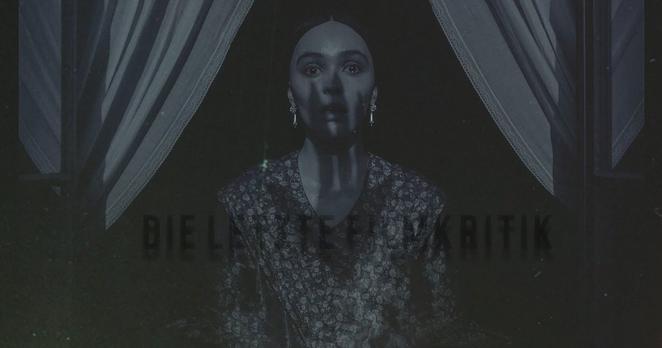 Lily-Rose Depp in Robert Eggers' Remake von Nosferatu als Coverbild des Podcasts "Die Letzte Filmkritik". Die junge Frau steht zwischen auseinander gezogenen Gardinen am offenen Fenster. Auf ihrem Gesicht ist der bedrohliche Schatten einer ausgestreckten Hand mit spitzen Fingernägeln erkennbar. Das Bild ist in leicht bläulichem, monochromem Farbton gehalten, der an ausgeblichene Schwarz-Weiß-Optik erinnert.