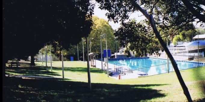 The Greensborough outdoor pool. Look at that shade. Olympic sized, I swam most of my youth here. From Prep to the end of High School. 

source https://www.flickr.com/photos/bootload/albums/72157706074401655/with/4483040153