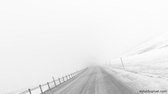 A snowy road in black and white that is giving the illusion of tumbling down into nothing