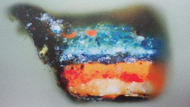 Sample with a vibrant blue layer above an orange one with red and yellow, and a black edge - from an English painting dated 1263, using azurite to depict blue feathers.