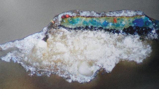 Sample with white layer over a thin layer of gold, above greeny-blue, then black, and a thick white substrate. From an English painting dated 1390, described as a gold leaf layer with chalk ground, depicting gilded blue.