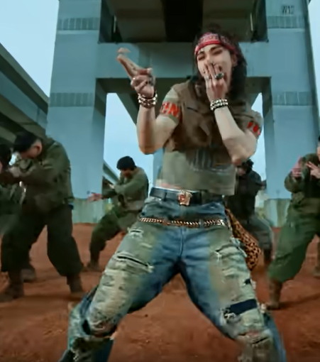 Hyunjin dancing while wearing jeans with a leopard-print bandana attached to the left hip.