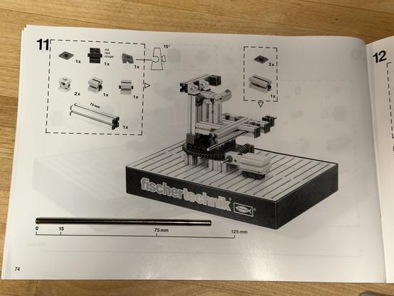 A page of the building instructions showing a scale next to the axle. It should be 125 mm long but is instead only 110 mm long.