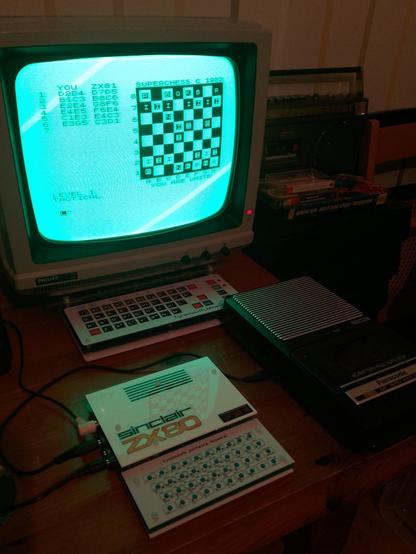 Photo of my ZX80 clone running Super Chess, written for the ZX81. Picture shows the tiny ZX80 in front of my Jupiter Ace clone and green screen CRT monitor.