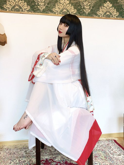 Miko himar sitting with her feet drawn up