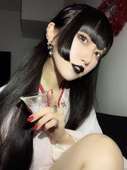 Hima as a miko with a small sake glass