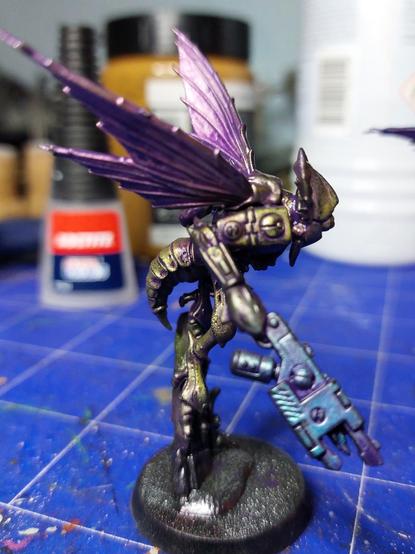 Some sort of space Wasp with helmet and gun.

Mostly painted

Gun is turquoise metallic; body greenish gold; wings orange. All washed with a heavy purple oil wash
