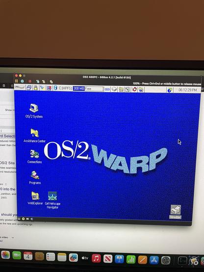 The image displays a computer screen running OS/2 Warp, featuring a blue desktop with various icons, including "OS/2 System," "WebExplorer," and "Get Netscape Navigator." The top bar shows system information and a vintage interface