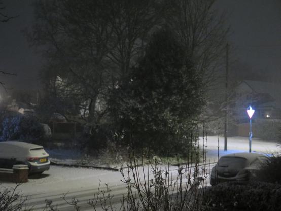 It's dark, there's a little bit of snow outside (and you cant tell that it's actually snowing)