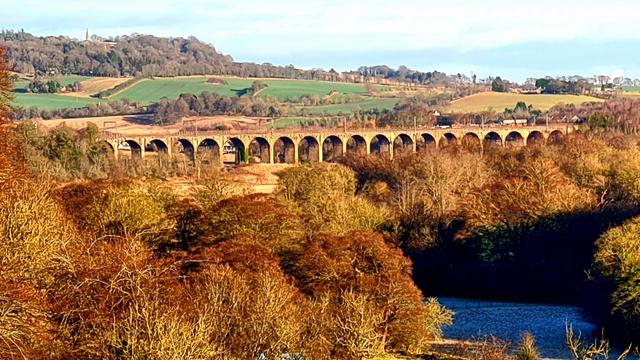 An early Victorian stone viaduct crossing a river in Central Scotland.