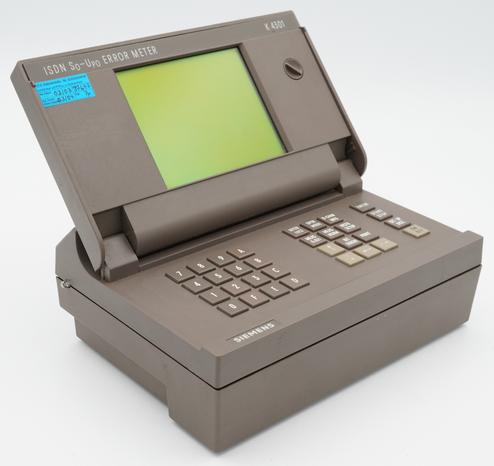 View of a Siemens K4301 ISDN S0-Up0 Error Meter; The display is folded up/open, revealing the keyboard underneath.