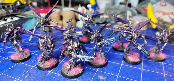 colourful and shiny wasp dudes with guns standing on pieces of ruin with neon coloured grass growing around