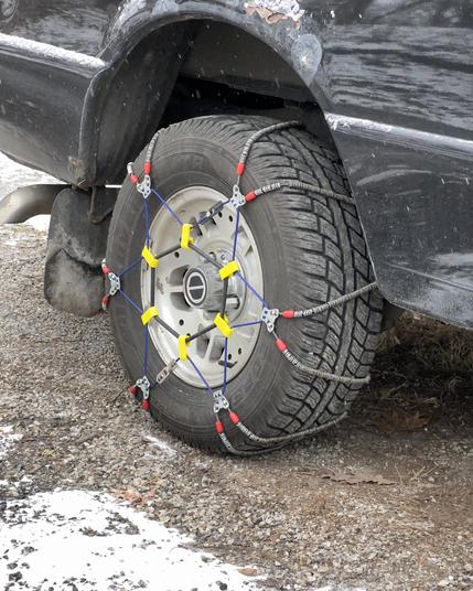 Image of snow chains installed on rear wheel drive 1994 Ford Ranger Truck.