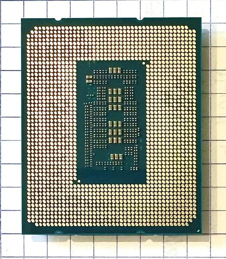 The underside of the chip. A deep green PCB with shiny golden pads. There are about 1700 of them, and if you look closely, you can see patterns in the almost uniform rows and columns surrounding the center rectangular island of capacitors and resistors. The patterns correspond to the LGA1700 socket specification for power, control, and data transfer. The section I analysed is at the top, centre.
